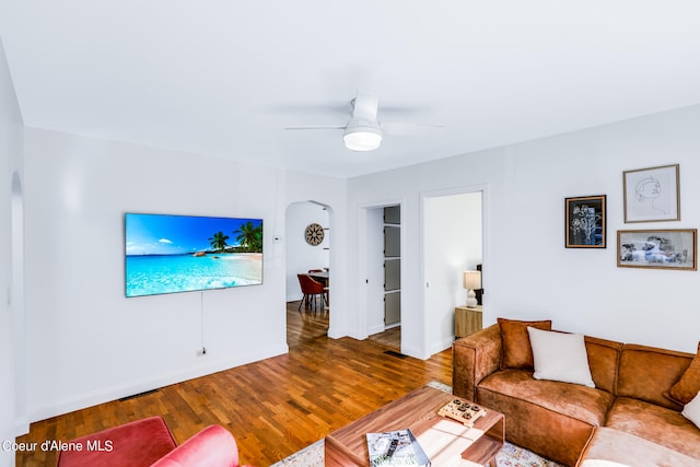 living room featuring ceiling fan and hardwood / wood-style floors