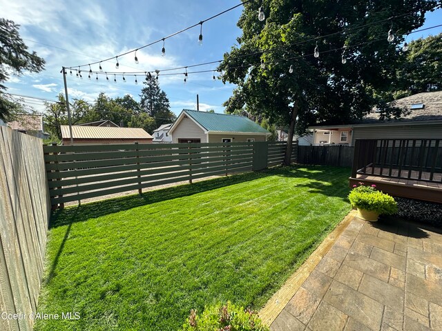 view of yard with a deck and a patio area