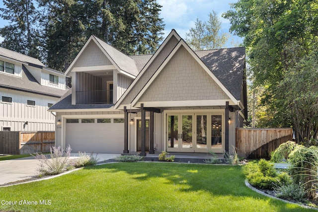 view of front of property with a garage and a front lawn