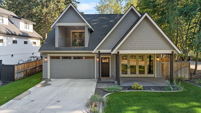 view of front of house with a garage and a front lawn