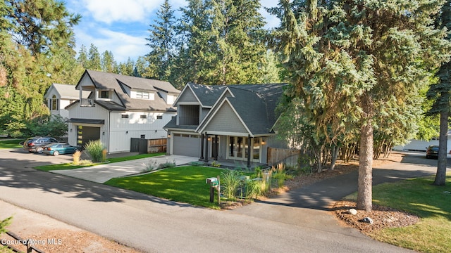 view of front of house featuring a garage and a front lawn