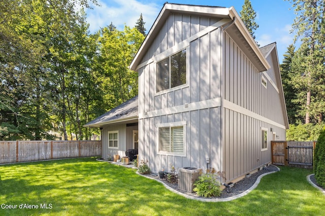 exterior space with cooling unit and a lawn