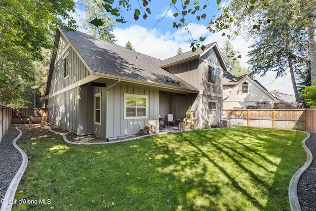 rear view of house with a yard and a patio