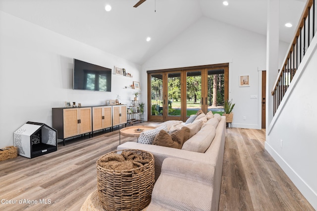 living room featuring light wood-type flooring, high vaulted ceiling, and ceiling fan