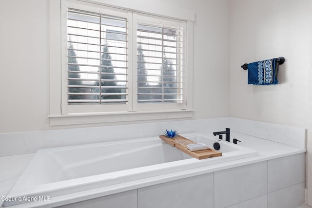 bathroom featuring tiled bath