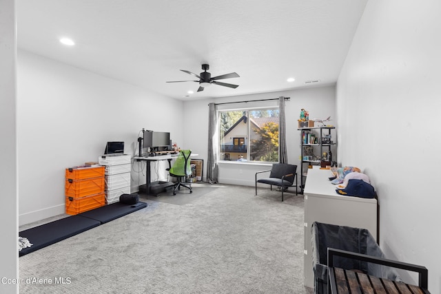 carpeted office featuring ceiling fan