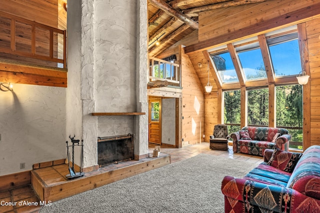 living room with lofted ceiling with beams, a fireplace, wood walls, and wooden ceiling