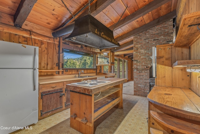 kitchen with white appliances, wooden ceiling, lofted ceiling with beams, and wooden walls