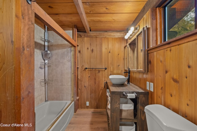 full bathroom with vanity, wood ceiling, wood walls, and toilet