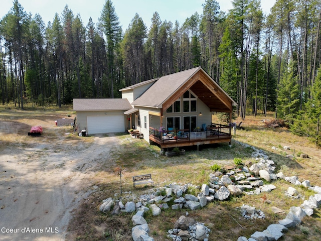 view of front of home featuring a garage and a wooden deck