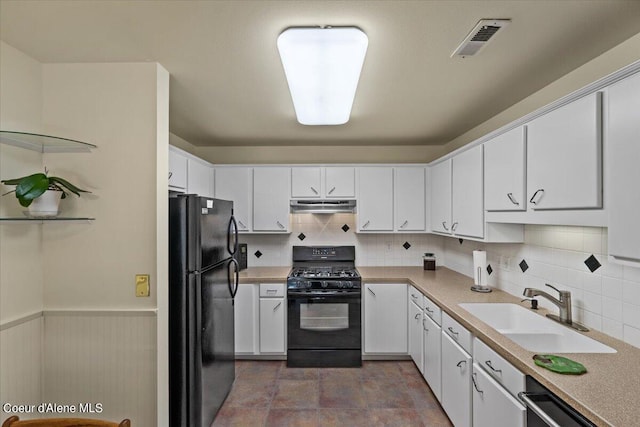 kitchen featuring black appliances, sink, white cabinets, and decorative backsplash