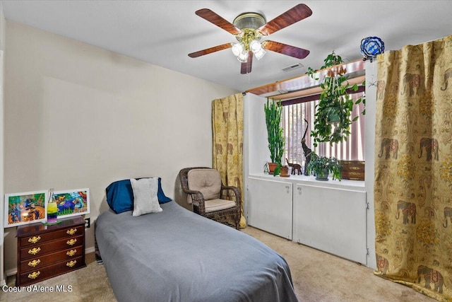 bedroom with ceiling fan and light carpet