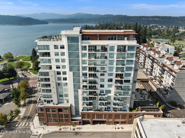 view of building exterior featuring a water and mountain view