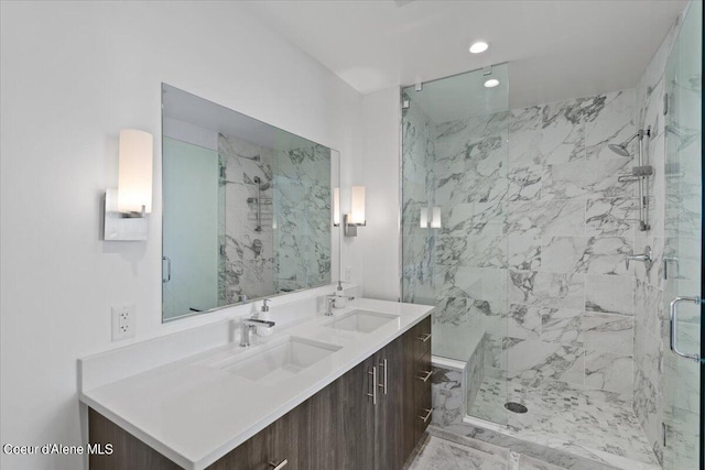 bathroom with a shower with shower door and vanity