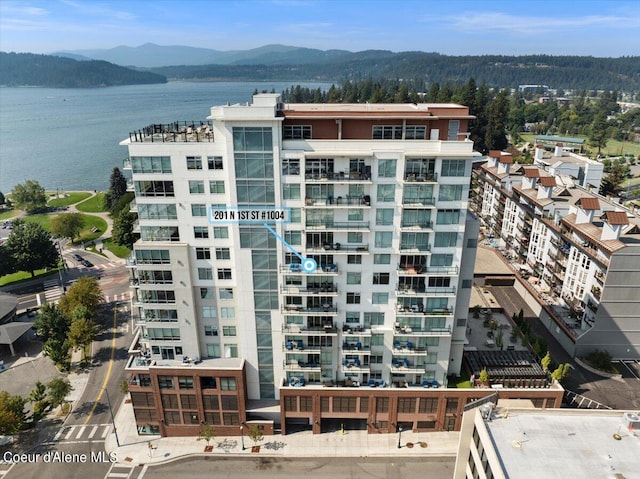 view of building exterior with a water and mountain view