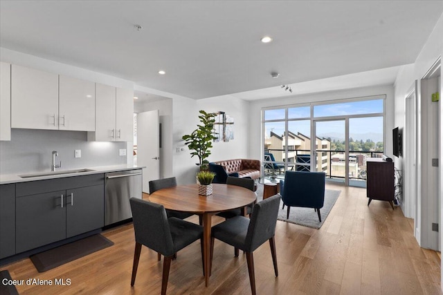 dining area with light hardwood / wood-style flooring and sink