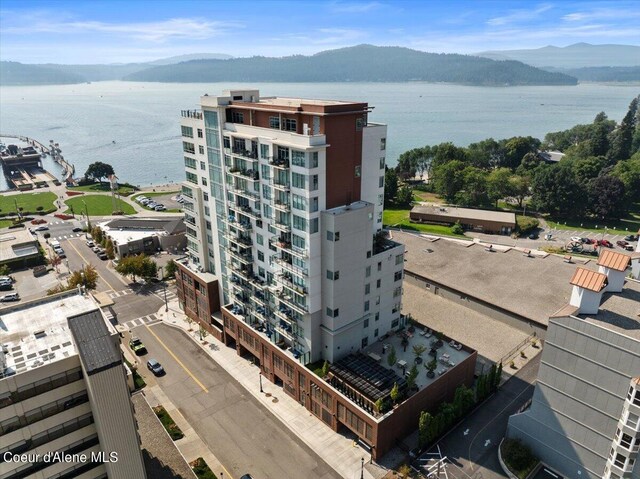 drone / aerial view with a water and mountain view