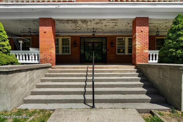 view of exterior entry with covered porch