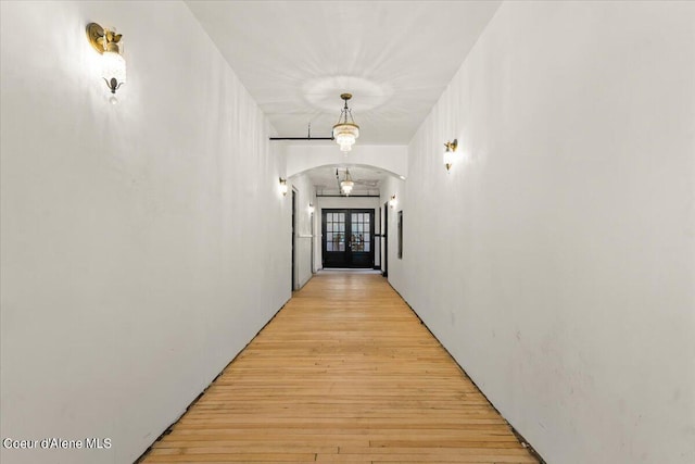 corridor with light hardwood / wood-style floors