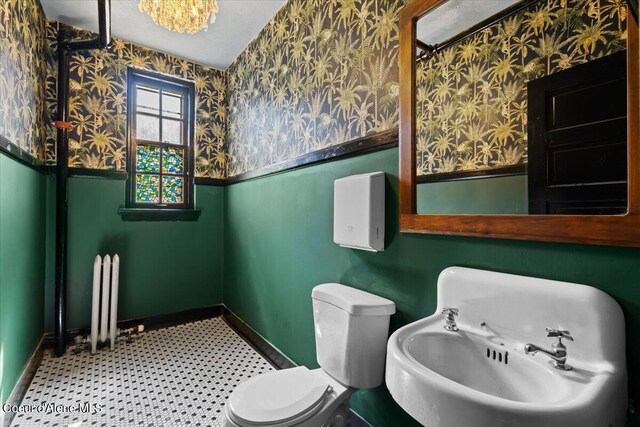 bathroom featuring toilet, a textured ceiling, and sink