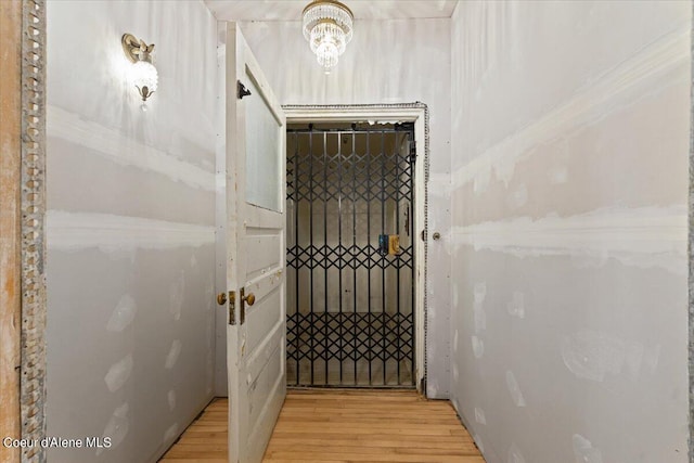 staircase featuring hardwood / wood-style floors and a chandelier