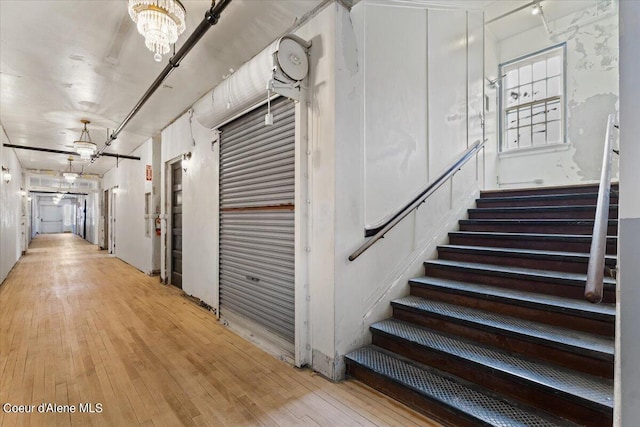 interior space featuring an inviting chandelier and light hardwood / wood-style floors