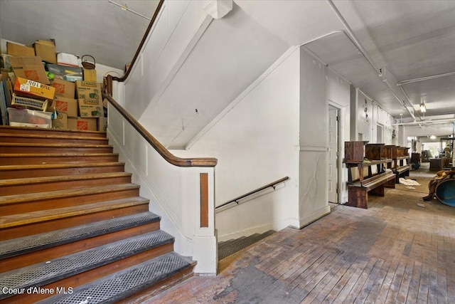 stairs featuring hardwood / wood-style flooring