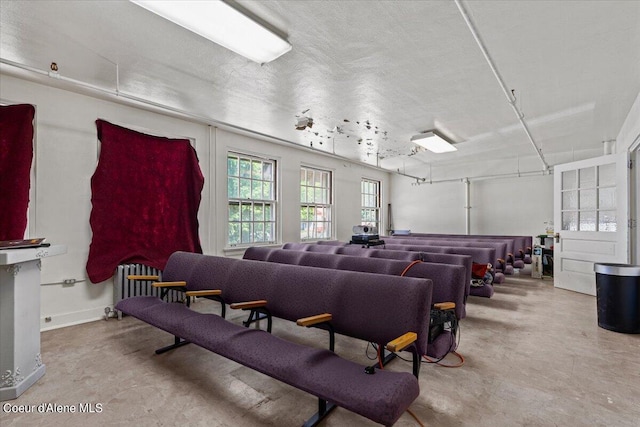 interior space featuring radiator, concrete floors, and a textured ceiling