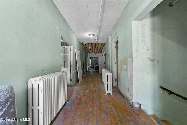 corridor with radiator and dark wood-type flooring