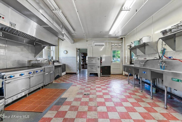 kitchen featuring an AC wall unit and decorative backsplash