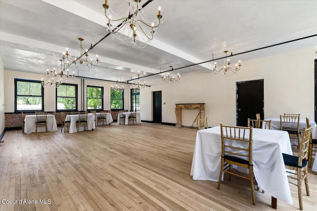 dining space featuring a notable chandelier and light hardwood / wood-style floors