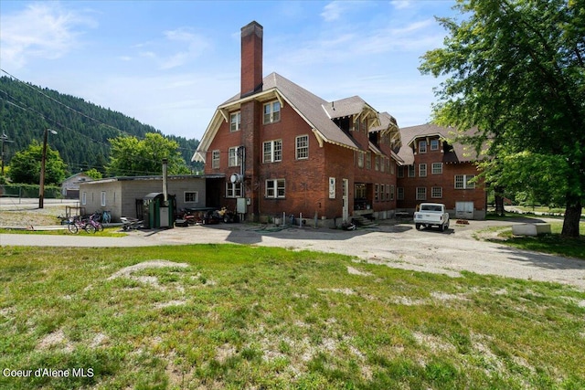 rear view of property with a yard