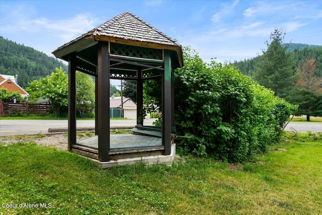 view of property's community with a lawn and a gazebo