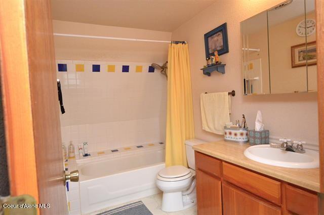 169 Westfall Ln, Kamiah, ID 83536 - bathroom featuring toilet, vanity, and shower / tub combo with curtain