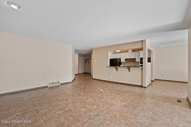 unfurnished living room with light tile patterned floors