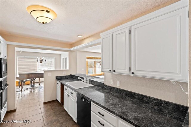 kitchen with hanging light fixtures, appliances with stainless steel finishes, white cabinetry, sink, and kitchen peninsula