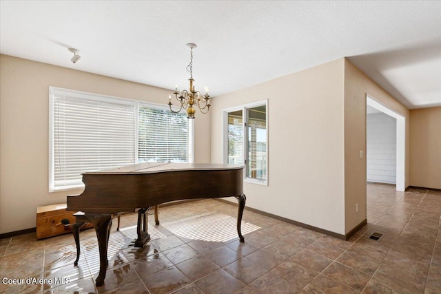 miscellaneous room featuring plenty of natural light and an inviting chandelier