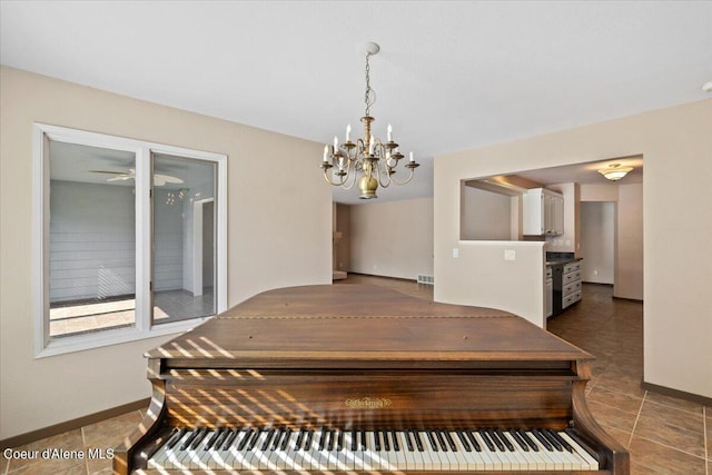 miscellaneous room with ceiling fan with notable chandelier and tile patterned floors