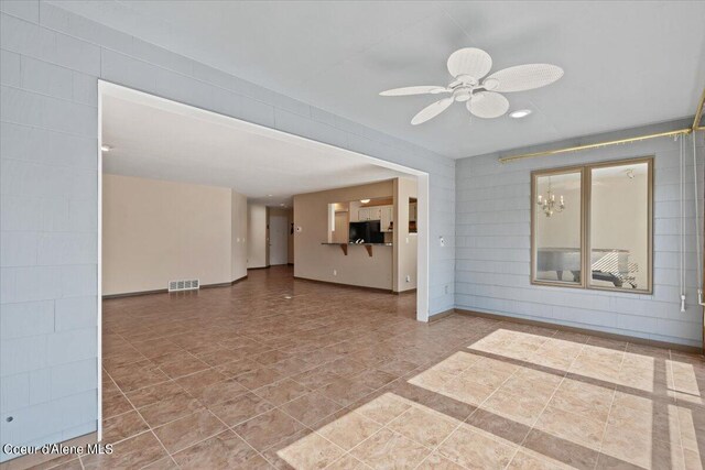 unfurnished living room featuring ceiling fan and light tile patterned floors