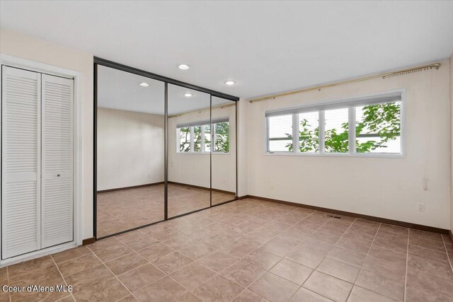 unfurnished bedroom with light tile patterned floors