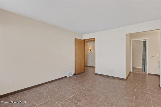 spare room with tile patterned floors