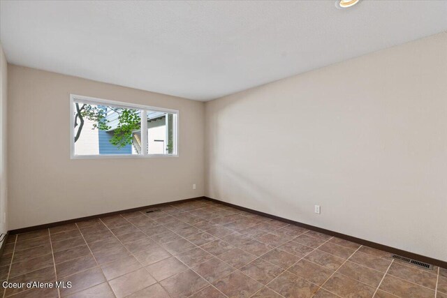 unfurnished room featuring tile patterned flooring