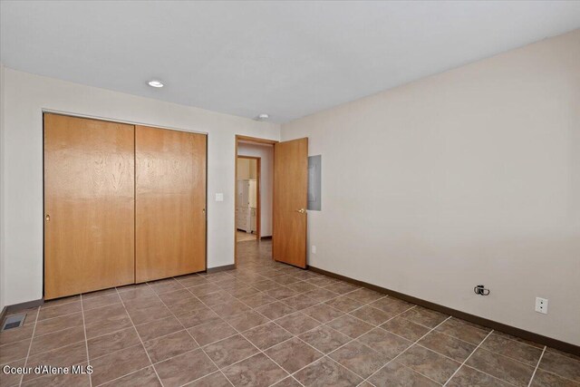 unfurnished bedroom featuring a closet and tile patterned floors