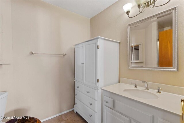 bathroom with tile patterned flooring, vanity, and toilet