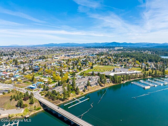 birds eye view of property with a water and mountain view