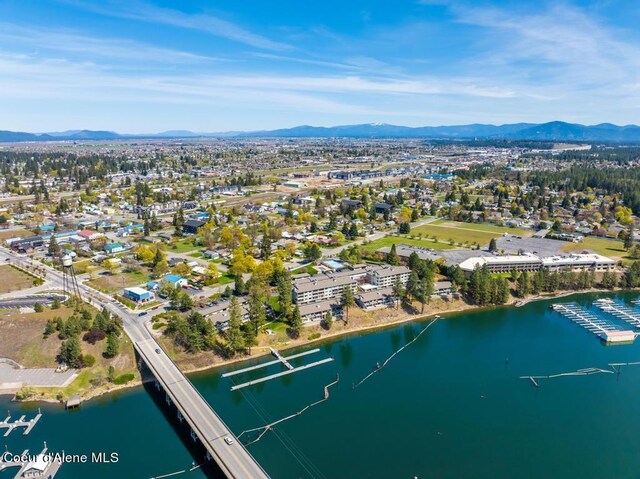 birds eye view of property with a water and mountain view