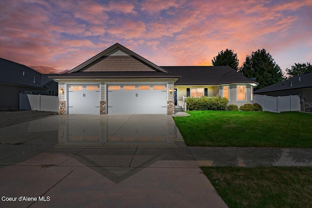 view of front of house featuring a garage and a yard