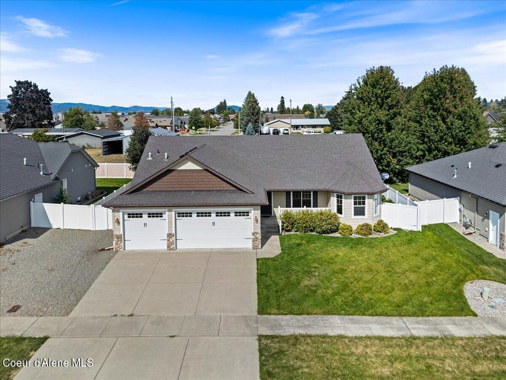 view of front of house featuring a front yard and a garage