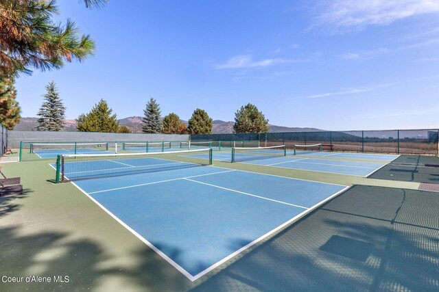 view of tennis court with a mountain view