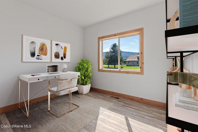 office area with light hardwood / wood-style floors